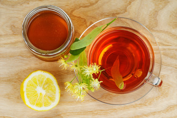 Herbal tea, jar of honey, lemon and linden blossom