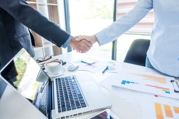 Businessman shaking hands after meeting over business office desk