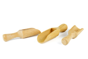 Three empty wooden scoops isolated on white background