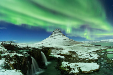 Aurora Borealis or northern light above kirkjufell mountain in iceland