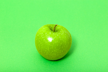 Fresh apple on green background