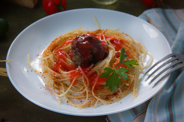 Traditional Italian spaghetti, pasta and meatballs with tomato sauce on a plate, on wooden background.