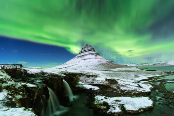 Aurora Borealis or northern light above kirkjufell mountain in iceland