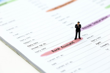 Miniature people : businessman standing with list of Credit Card,concept for Business,tax,money