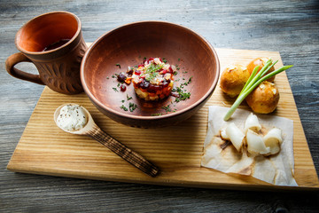 wooden table topped with plates of traditional ukrainian food