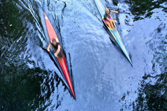 Two kayaks at speed in the water