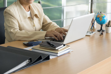 Business woman working with laptop at business office. Selective focus.