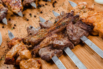 shish kebab assortment. a variety of meat. On the wooden table.