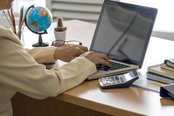 Business woman working with laptop at business office. Selective focus.