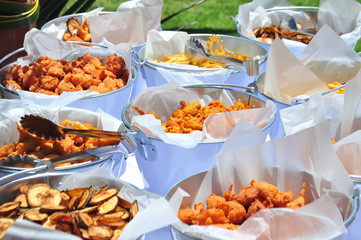 buckets of fried chicken, fish, zucchini and French fries