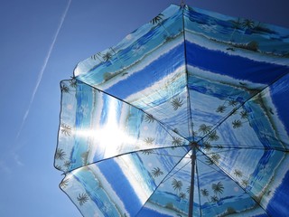 Sun Beach Umbrella Parasol on Sunny Day on Background of Blue Sky Giving Shade and Protection