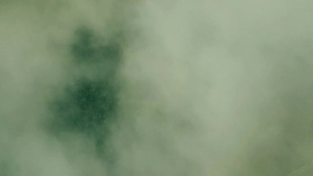 Descending through the clouds to wild forest, concept of fast unmanaged falling down