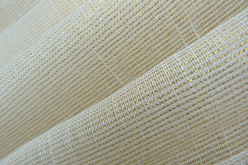gold brocade fabric close-up natural linens creases padding oriental luxury shiny threads vintage organza curtains background for decor textured material uneven surface silk