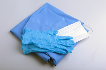 Medical stethoscope, gloves, RX prescription, and blue doctor uniform closeup. Medical help or insurance concept. Cardiology care, health, protection and prevention.