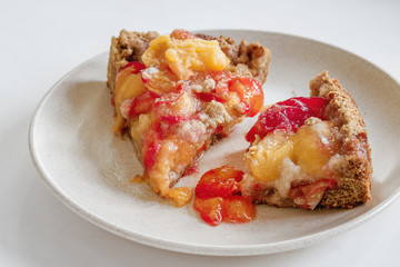 Plum Apricot Pie Home-made close-up on a white background in a cut