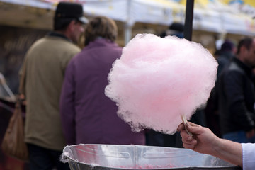 Cotton candy being made out of pink dyed sugar for joyful children. Concept of unhealthy eating, too much sugar. Diabetes.  
