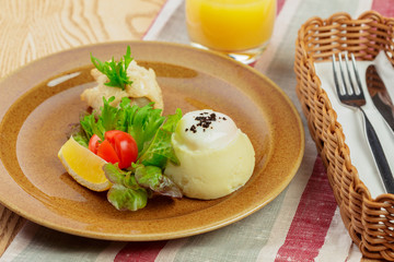 Mashed potatoes with egg yolk and fish slice