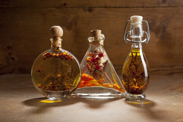 Bottles extra virgin olive oil with spices on a ceramic background
