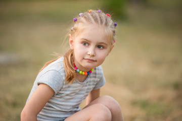 portrait of a little girl in a summer park