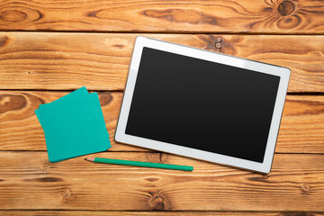 White digital tablet on wooden table