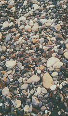 Sea pebble colorful wet background, vintage hipster image