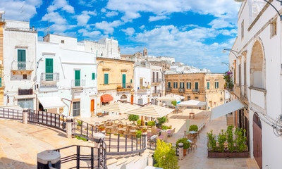 A lot of cafes on the favorite tourist area of Ostuni. Italy. Europe - obrazy, fototapety, plakaty