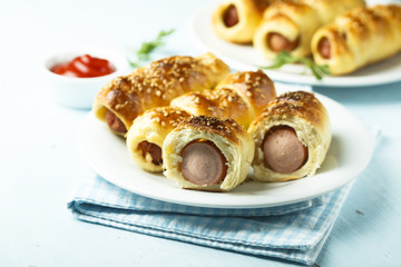 Homemade sausage rolls with sesame seeds