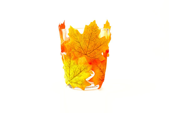 Drinking Glass Decorated with Artificial Autumn Leaves on White