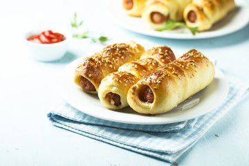 Homemade sausage rolls with sesame seeds