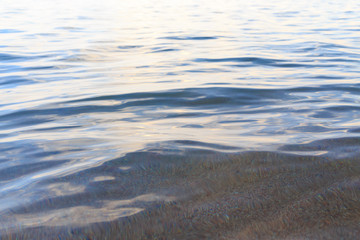 Blue clear water. Sea, lake, sun, beach, vacation Background for inserting images and text. Tourism, travel.