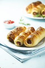 Homemade sausage rolls with sesame seeds