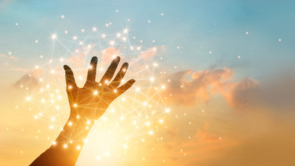 Hand touching global network connection and  data exchanges on sky sunset background. Technology and telecommunication concept.