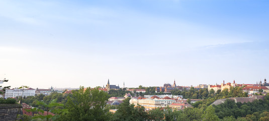 Fototapeta premium Panorama of Prague and view onto bridges over river Vltava and traditional red roofs in old town of Prague