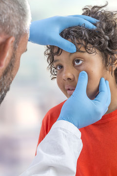 ophthalmology. eyes exam, male doctor examining teen patien teyes