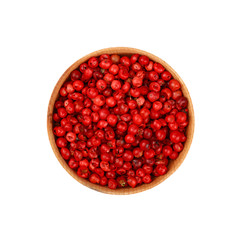 Wooden bowl full of pink peppercorns