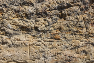 Texture of an old wall. Surface of an ancient temple in Prague. Background of stone for the designer. Vintage pattern in brown tones