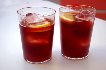 Two glasses with vine cocktail, lemon and ice, summer