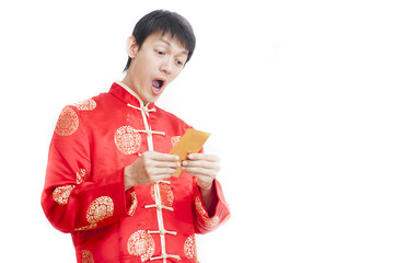 Southeast Asian male in cheongsam hands holding red packets ,ang pow , isolated on white background.