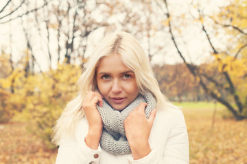 Autumn woman with blonde hair outdoor portrait, female face closeup