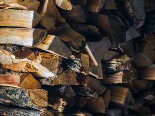 Preparing for winter and making cold season warmer concept: stack of firewood as a graphic resource...