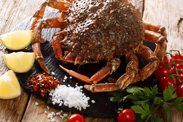 Gourmet food: raw spider crab with ingredients for cooking close up on a table. Horizontal