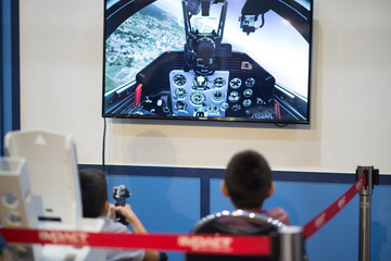 Littl boy playing a aircraft simulator