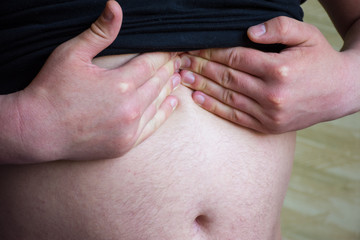 Patient holds on with both hands to epigastrium, pressing by fingers on projection of stomach or...