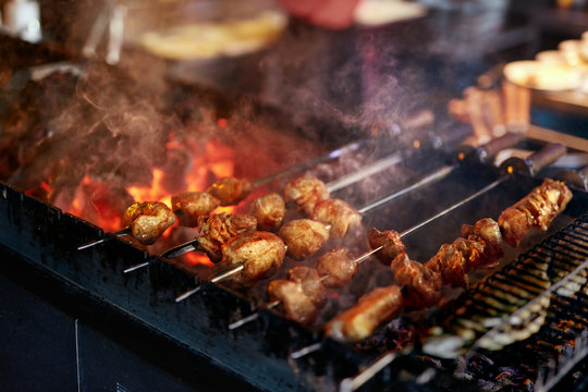 Grilling Meat On Skewers. Barbecue Meat Pieces Cooking On Grill