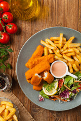 Fish sticks with fries and salad.