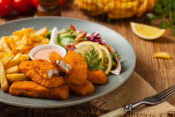 Fish sticks with fries and salad.