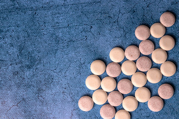set of round tablets collected by a large group on a blue background