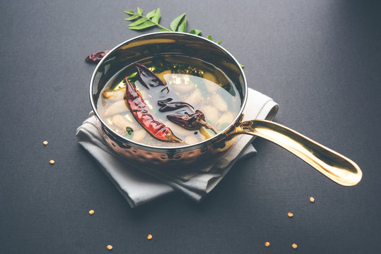 chaunk / Tadka / Tempering spices also known as baghaara, fodni, tarka or vaghaar. Typically prepared in special pan with handle. selective focus