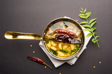 chaunk / Tadka / Tempering spices also known as baghaara, fodni, tarka or vaghaar. Typically prepared in special pan with handle. selective focus