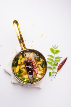 chaunk / Tadka / Tempering spices also known as baghaara, fodni, tarka or vaghaar. Typically prepared in special pan with handle. selective focus